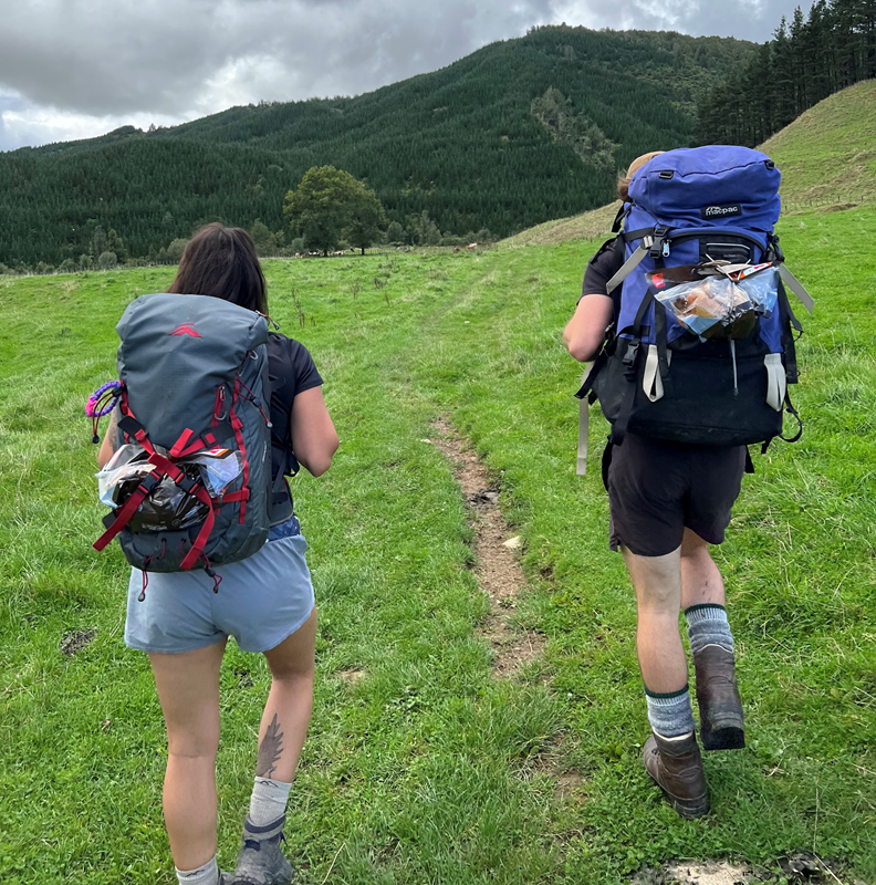 Kathleen & Lochie with chickens strapped to their packs